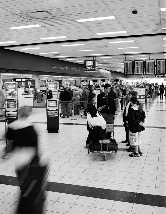 Photo: A passenger information representative assists travellers at Toronto Pearson International Airport, Ontario